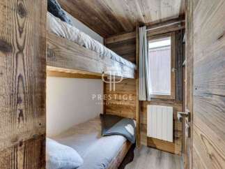 Discover the charm of this cozy bedroom featuring rustic wooden bunk beds, perfect for a mountain retreat.