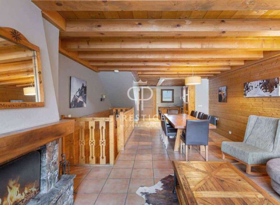 Experience the charm of this stunning property, featuring a cozy fireplace and rustic wooden beams.