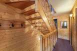 Discover the charm of this wooden-paneled interior, featuring a beautifully crafted staircase.