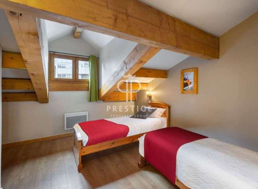 Charming bedroom with exposed wooden beams, creating a cozy and rustic atmosphere.