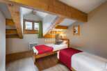 Charming bedroom with exposed wooden beams, creating a cozy and rustic atmosphere.
