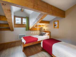 Charming bedroom with exposed wooden beams, creating a cozy and rustic atmosphere.