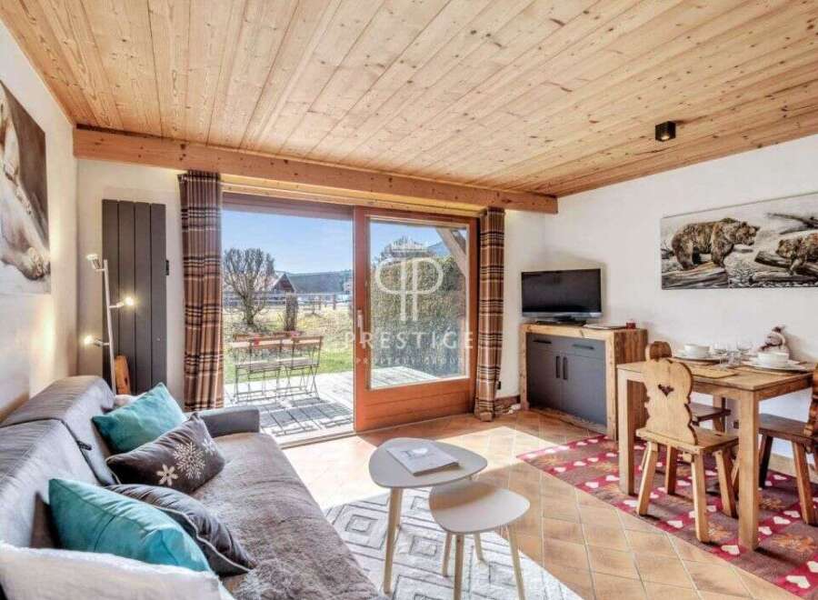 Discover a cozy retreat with this charming property, featuring a warm wooden ceiling and inviting living space.