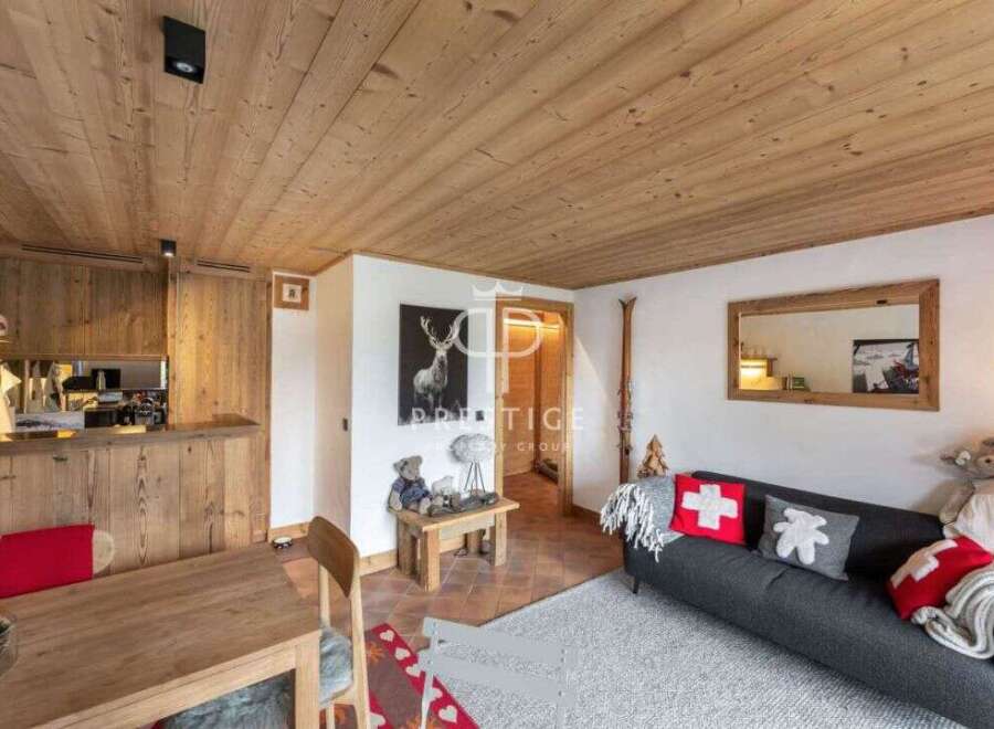 Experience the charm of this cozy chalet, featuring a warm wooden ceiling and inviting living space.