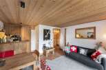 Experience the charm of this cozy chalet, featuring a warm wooden ceiling and inviting living space.