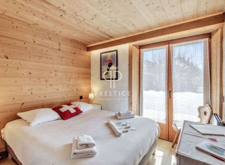 Experience the charm of this cozy bedroom, featuring warm wooden accents and a comfortable bed.