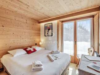 Experience the charm of this cozy bedroom, featuring warm wooden accents and a comfortable bed.