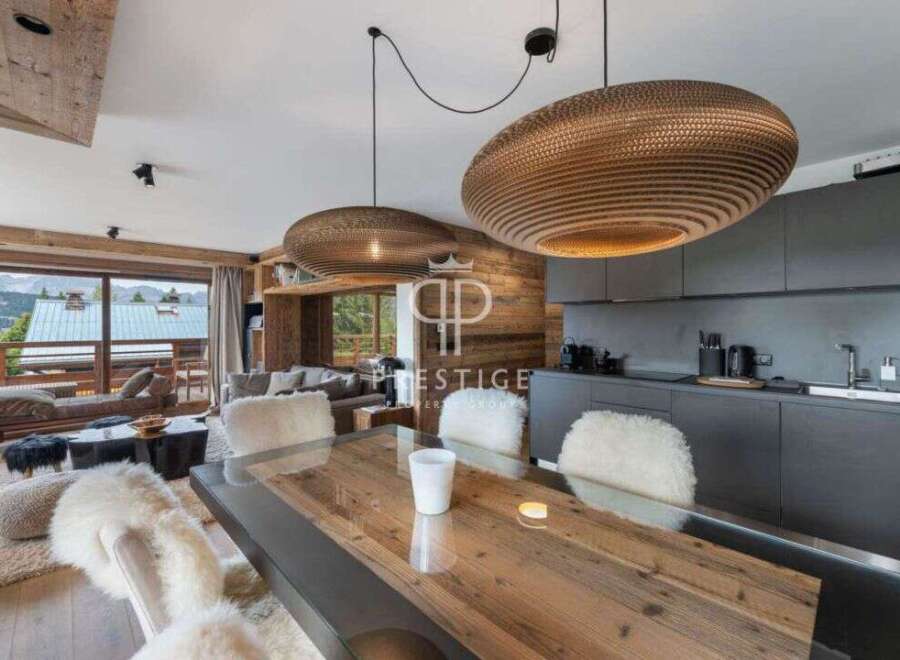 Experience luxury living in this stunning property, featuring a modern kitchen and a cozy living area.