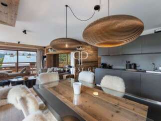 Experience luxury living in this stunning property, featuring a modern kitchen and a cozy living area.