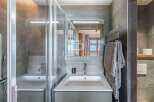 Discover a modern bathroom design featuring a sleek sink and a stylish shower enclosure.