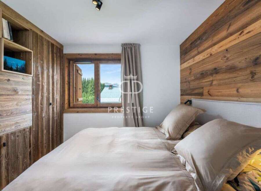 Experience the charm of this cozy bedroom, featuring a stunning wooden accent wall and built-in storage.