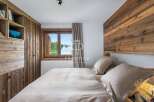Experience the charm of this cozy bedroom, featuring a stunning wooden accent wall and built-in storage.