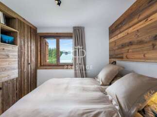 Experience the charm of this cozy bedroom, featuring a stunning wooden accent wall and built-in storage.