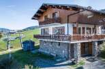 Discover a stunning chalet nestled in a picturesque mountain setting.