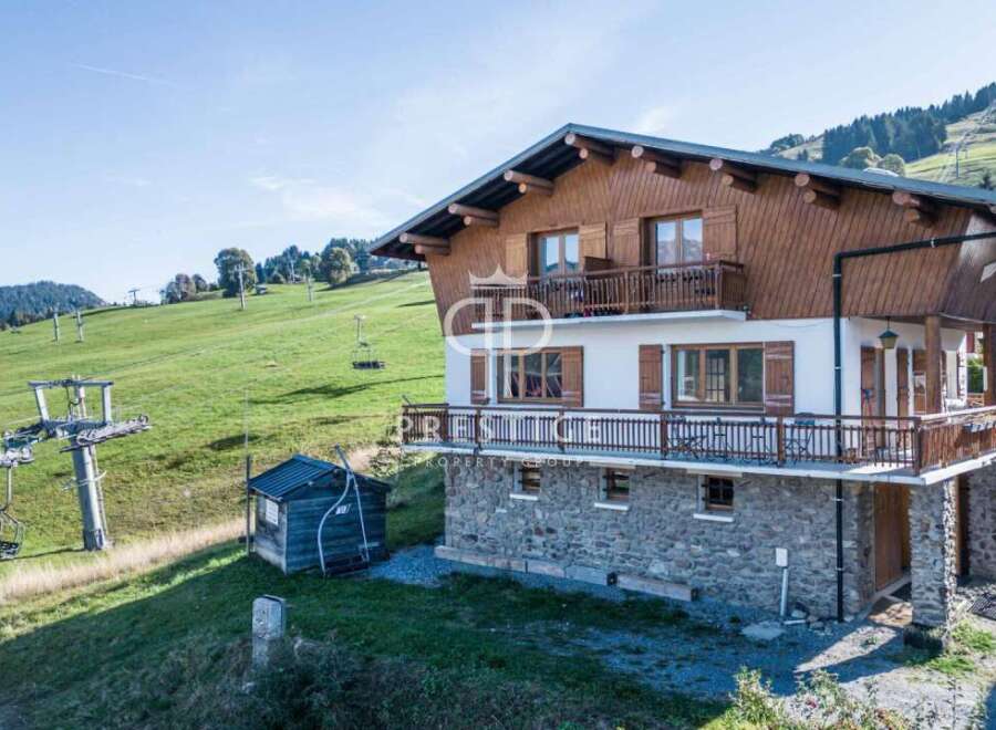 Discover a stunning chalet nestled in a picturesque mountain setting.