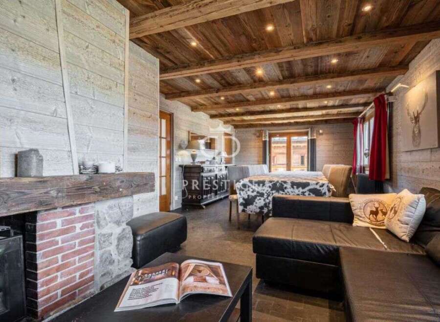 Experience rustic charm in this stunning property, featuring a cozy fireplace and exposed wooden beams.