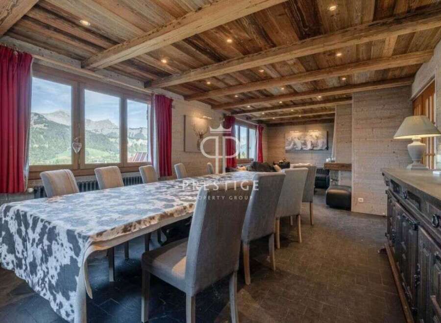 Experience luxury living in this stunning property, featuring a spacious dining area with a unique cowhide tablecloth.