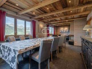 Experience luxury living in this stunning property, featuring a spacious dining area with a unique cowhide tablecloth.