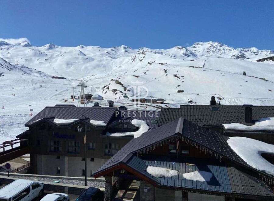 Discover a stunning property nestled in the heart of a snowy mountain landscape.