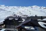 Discover a stunning property nestled in the heart of a snowy mountain landscape.
