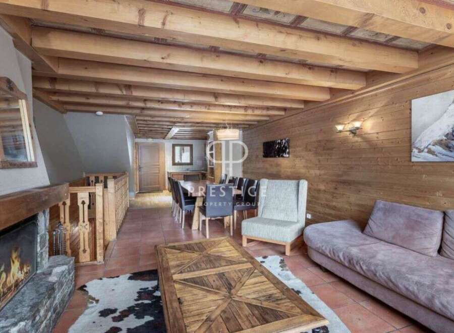 Experience the charm of this stunning property, featuring a cozy fireplace and a rustic wooden ceiling.