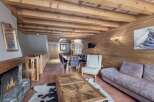 Experience the charm of this stunning property, featuring a cozy fireplace and a rustic wooden ceiling.