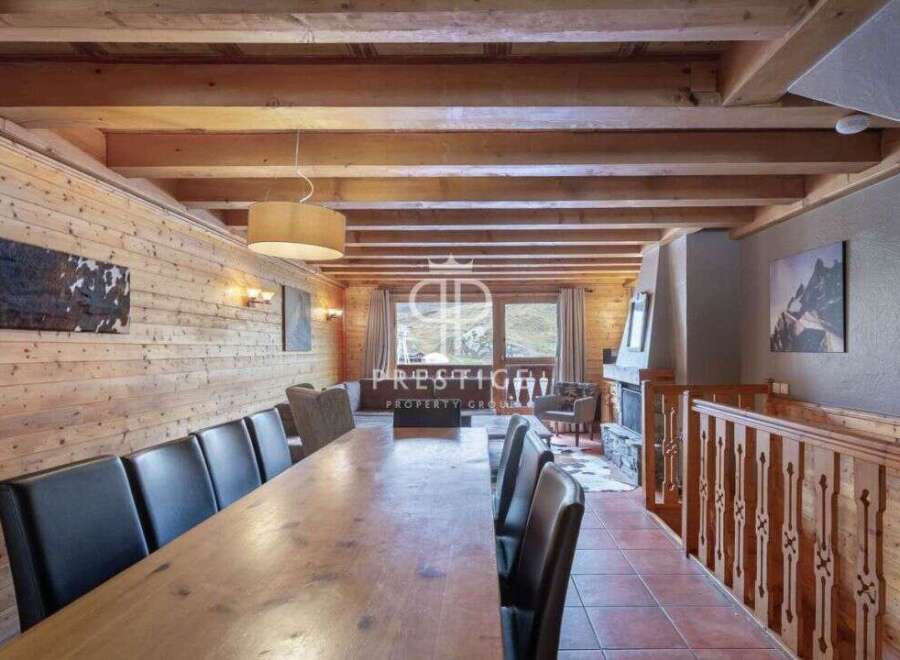 Experience luxury living in this stunning chalet, featuring a spacious dining area perfect for entertaining.