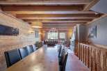 Experience luxury living in this stunning chalet, featuring a spacious dining area perfect for entertaining.