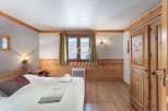 Discover a cozy bedroom with wooden accents, creating a warm and inviting atmosphere.