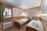 Cozy bedroom featuring two single beds with fresh linens.