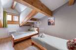 Discover a cozy bedroom with rustic wooden beams and a charming ambiance.