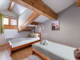 Discover a cozy bedroom with rustic wooden beams and a charming ambiance.
