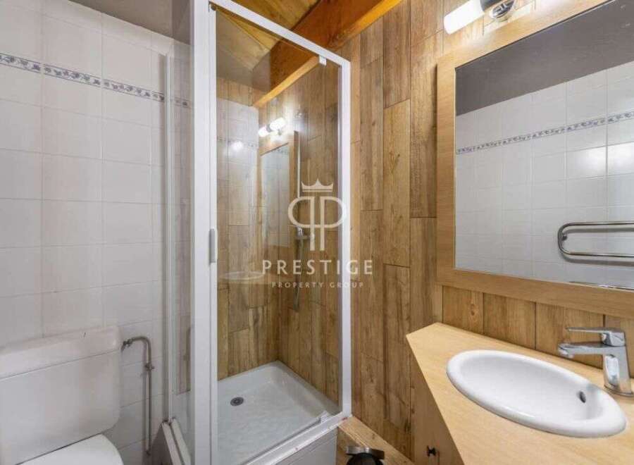 Discover a charming bathroom with a rustic wooden aesthetic.