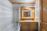 Discover a charming bathroom with a rustic wooden vanity and a bright, clean aesthetic.