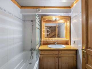 Discover a charming bathroom with a rustic wooden vanity and a bright, clean aesthetic.
