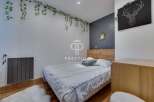 Discover a cozy bedroom retreat! This space features a stylish bed, complemented by a unique wall decor.