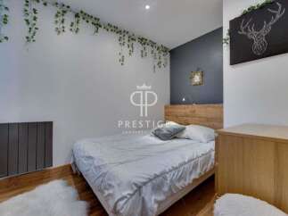 Discover a cozy bedroom retreat! This space features a stylish bed, complemented by a unique wall decor.