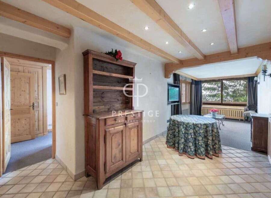 Discover the charm of this property, featuring a rustic wooden cabinet and elegant tiled flooring.