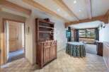 Discover the charm of this property, featuring a rustic wooden cabinet and elegant tiled flooring.