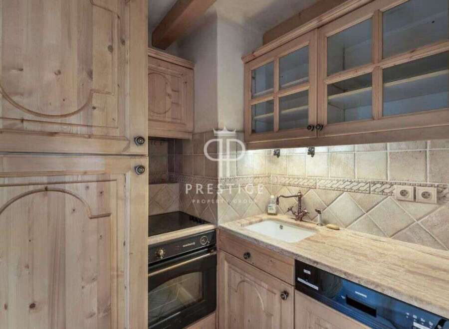 Discover the charm of this kitchen, featuring elegant wooden cabinetry and a cozy ambiance.