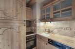 Discover the charm of this kitchen, featuring elegant wooden cabinetry and a cozy ambiance.