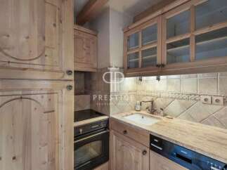 Discover the charm of this kitchen, featuring elegant wooden cabinetry and a cozy ambiance.