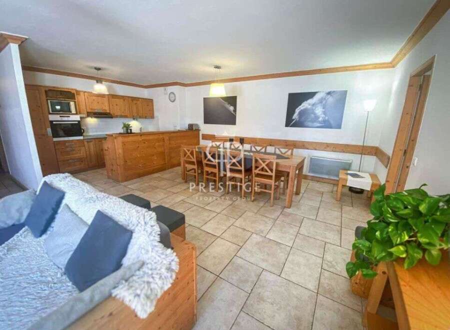 Discover a cozy retreat with this charming property, featuring a warm wooden interior and a well-equipped kitchen.
