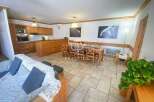 Discover a cozy retreat with this charming property, featuring a warm wooden interior and a well-equipped kitchen.