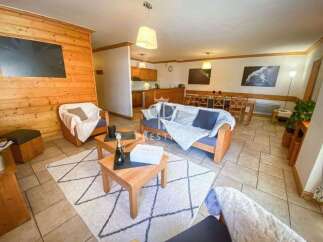 Discover a cozy living space with wooden accents and comfortable seating.