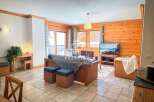 Discover the charm of this cozy living space, featuring warm wooden accents and a welcoming atmosphere.