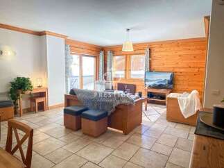 Discover the charm of this cozy living space, featuring warm wooden accents and a welcoming atmosphere.