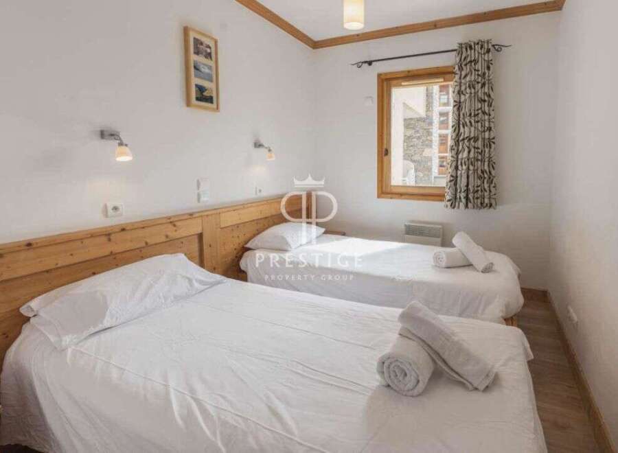 Discover a cozy bedroom with two comfortable beds, perfect for a relaxing stay.