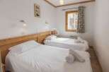 Discover a cozy bedroom with two comfortable beds, perfect for a relaxing stay.