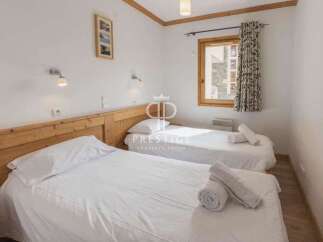 Discover a cozy bedroom with two comfortable beds, perfect for a relaxing stay.